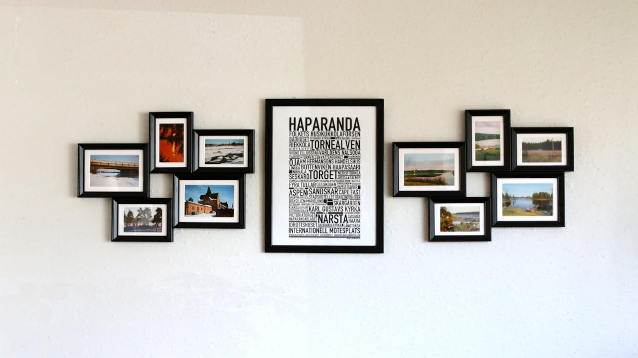 Elegant wall art with black frames showcasing Haparanda themes and landscape photos.