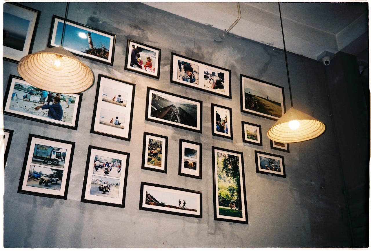 Artistic arrangement of framed photos on a rustic gray wall in a cozy room.
